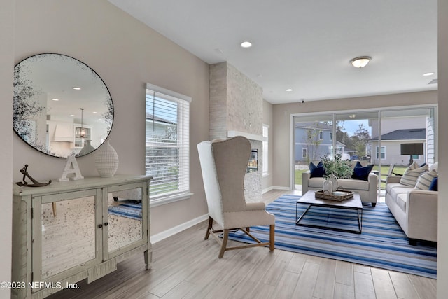 living room featuring a stone fireplace