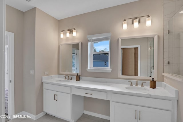 bathroom with a shower with shower door and vanity