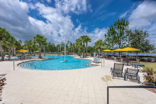 view of pool with pool water feature and a patio area