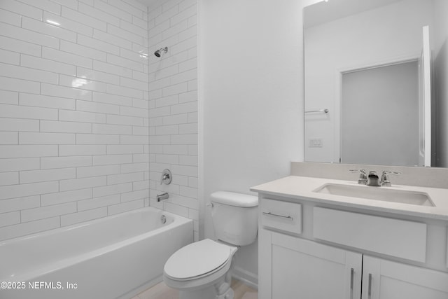 full bathroom featuring vanity, tiled shower / bath combo, and toilet