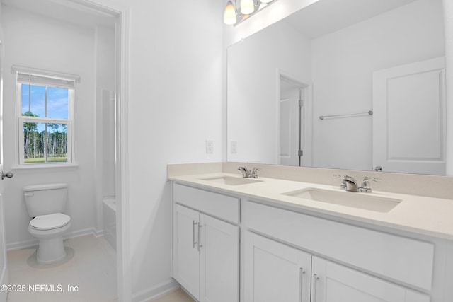 bathroom featuring vanity, tile patterned floors, and toilet