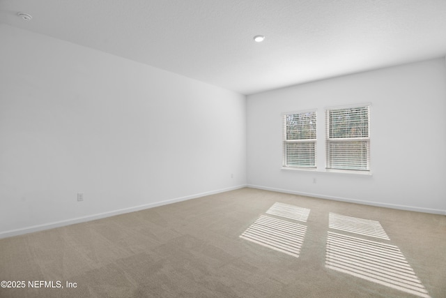 unfurnished room with light carpet