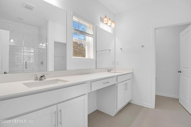 bathroom with tile patterned flooring, vanity, and a shower with shower door