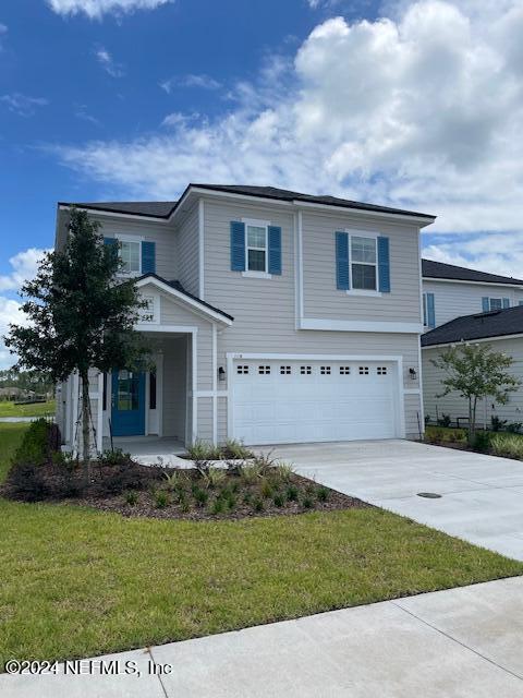 view of front of house featuring a garage and a front yard