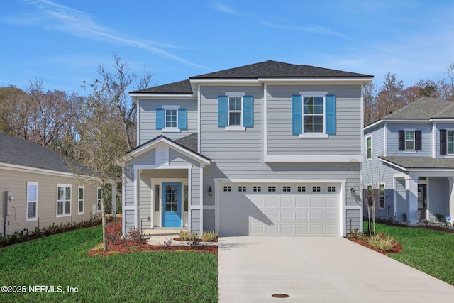 view of front property featuring a garage and a front lawn