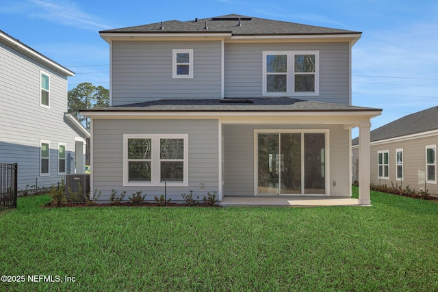 rear view of property featuring a patio and a yard