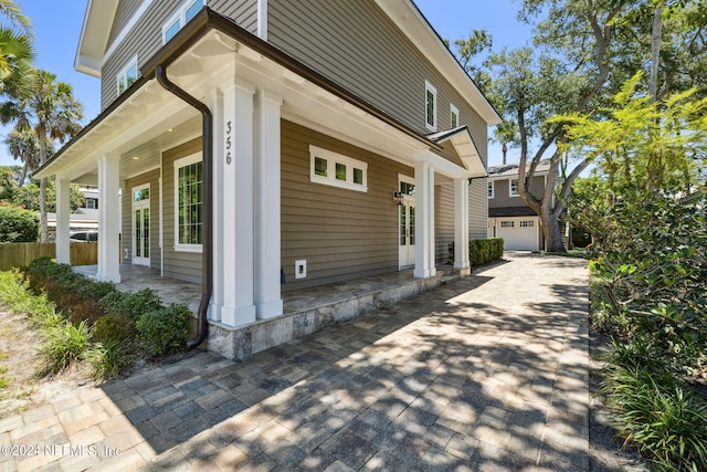 view of home's exterior with a porch and a garage