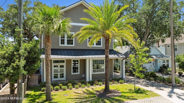 view of front of home featuring a front yard and french doors