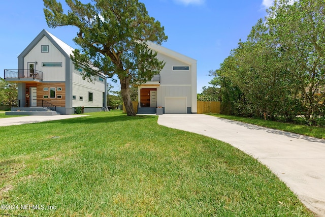 contemporary home with a garage and a front lawn