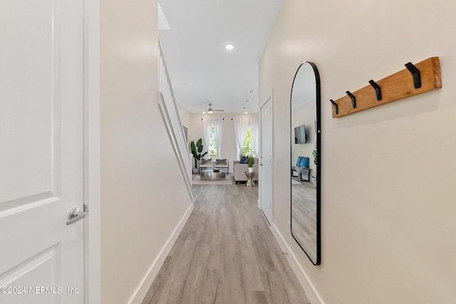 hallway with light hardwood / wood-style flooring