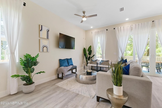 living room featuring light wood-type flooring and ceiling fan