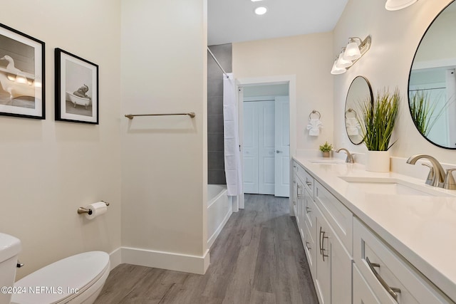 full bathroom featuring shower / tub combo with curtain, toilet, vanity, and hardwood / wood-style flooring