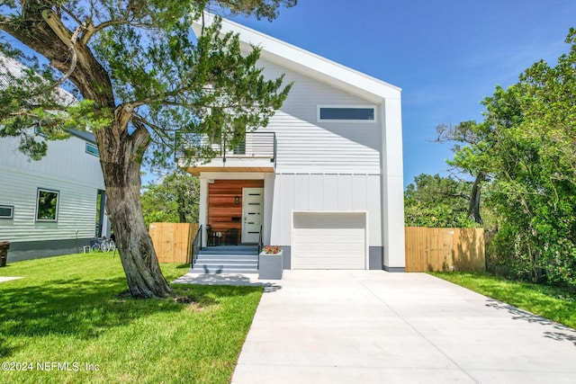 modern home with a front yard and a garage