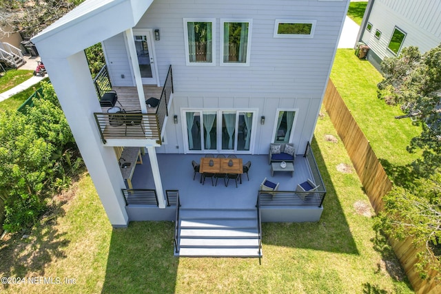 rear view of house featuring a yard