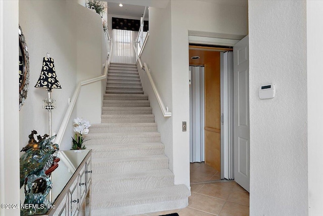 stairs featuring tile patterned floors