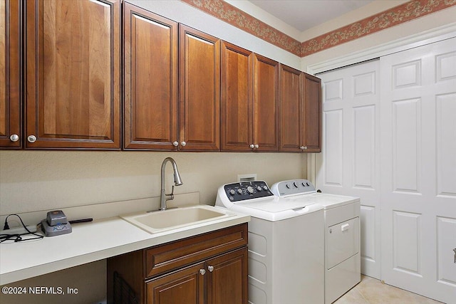 laundry area with light tile patterned flooring, cabinets, sink, and washing machine and dryer