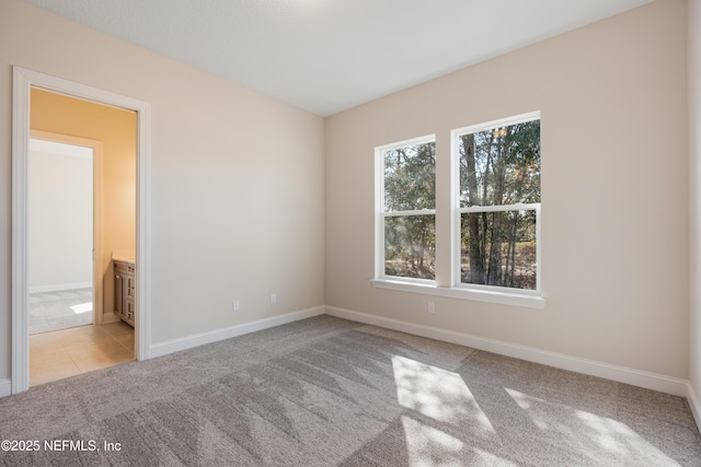 unfurnished room with light colored carpet