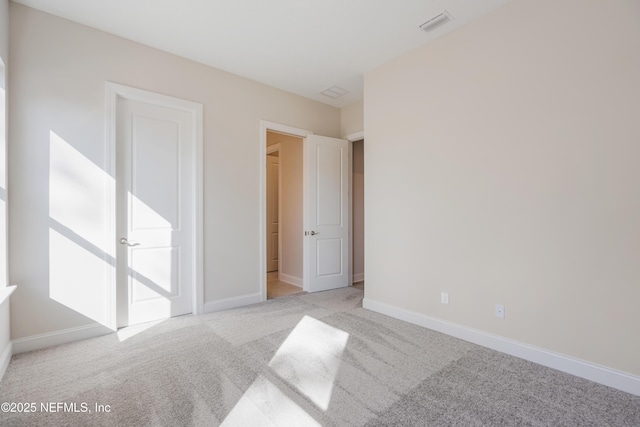 bedroom featuring light carpet, visible vents, and baseboards