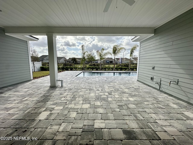 view of patio / terrace with a fenced backyard, a community pool, and ceiling fan