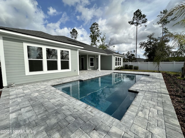 view of swimming pool featuring a fenced backyard, a fenced in pool, and a patio