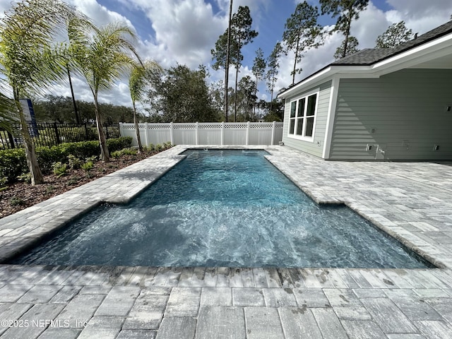 view of swimming pool featuring a patio, a fenced backyard, and a fenced in pool