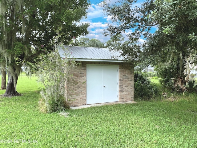 view of outbuilding featuring a lawn