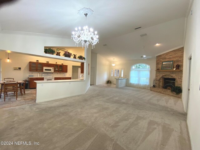 carpeted living room featuring crown molding, a fireplace, ceiling fan with notable chandelier, and lofted ceiling