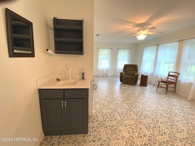 bathroom featuring ceiling fan, visible vents, vanity, and baseboards