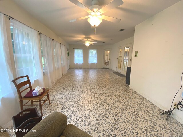 living room featuring french doors and ceiling fan