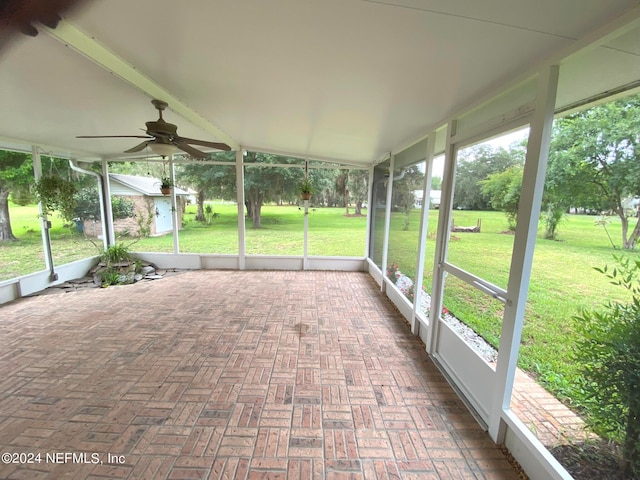 unfurnished sunroom featuring ceiling fan and lofted ceiling