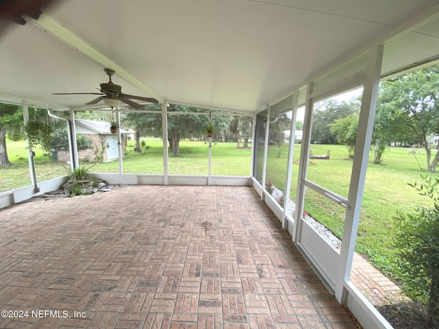 unfurnished sunroom with a ceiling fan