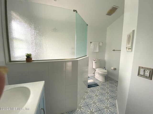 bathroom featuring tile patterned flooring, vanity, and toilet