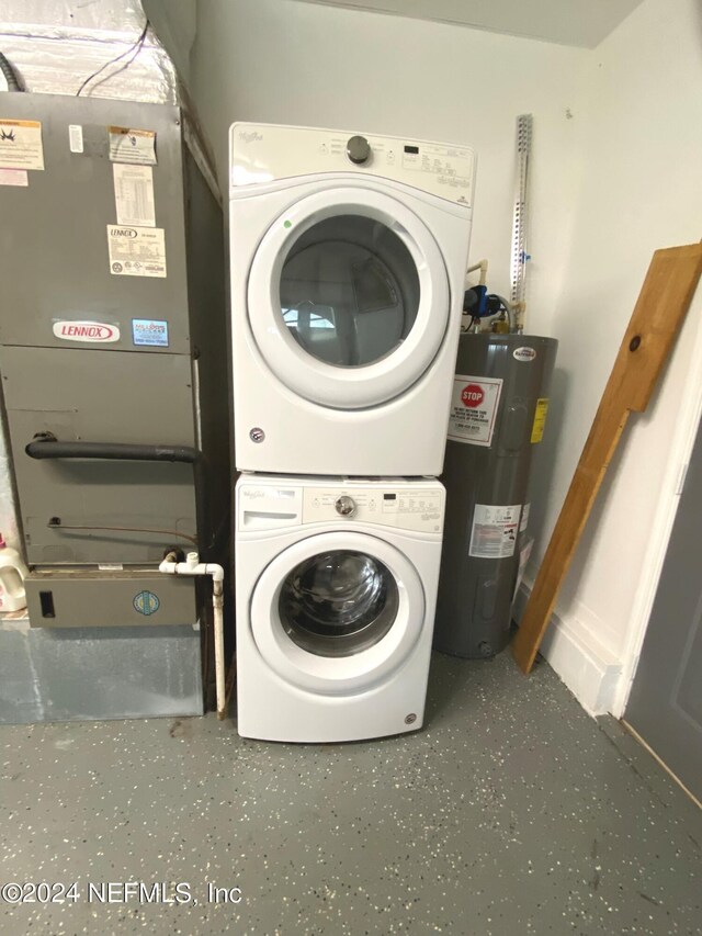 laundry room with electric water heater and stacked washer and dryer