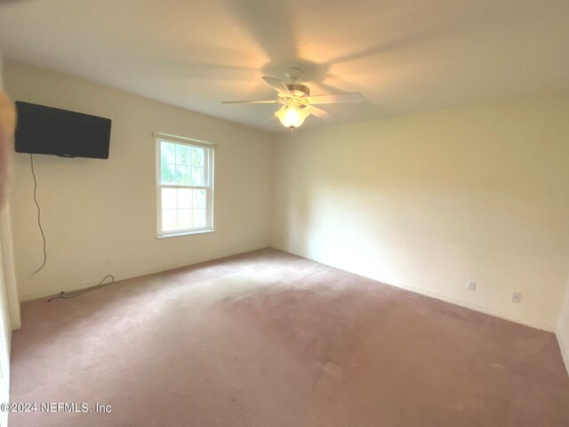 carpeted spare room with ceiling fan