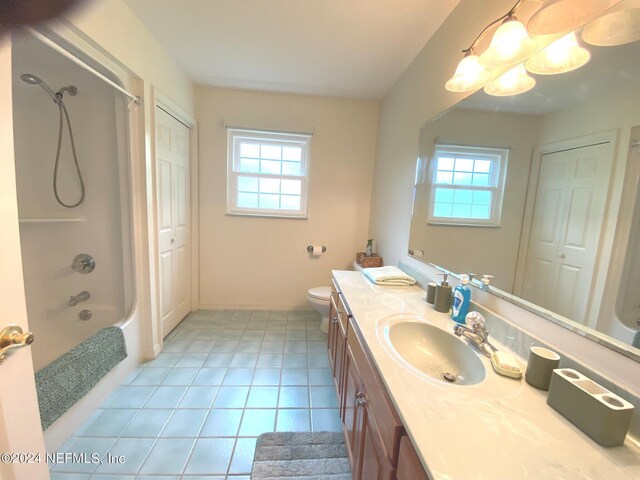 full bathroom featuring tile patterned floors, vanity, toilet, and bathtub / shower combination