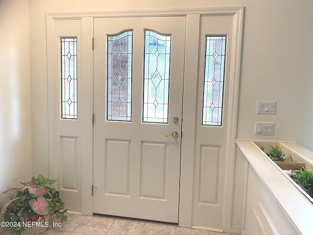 foyer entrance with light tile patterned floors