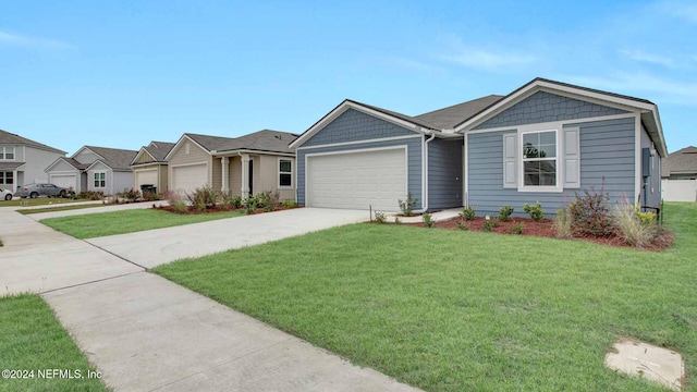 view of front of house with a garage and a front lawn