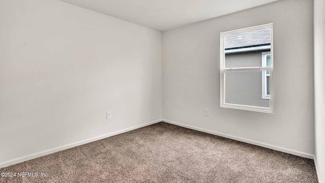 unfurnished room featuring carpet