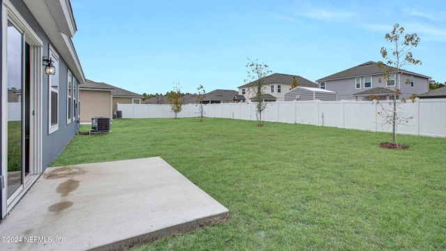 view of yard with a patio and central AC unit