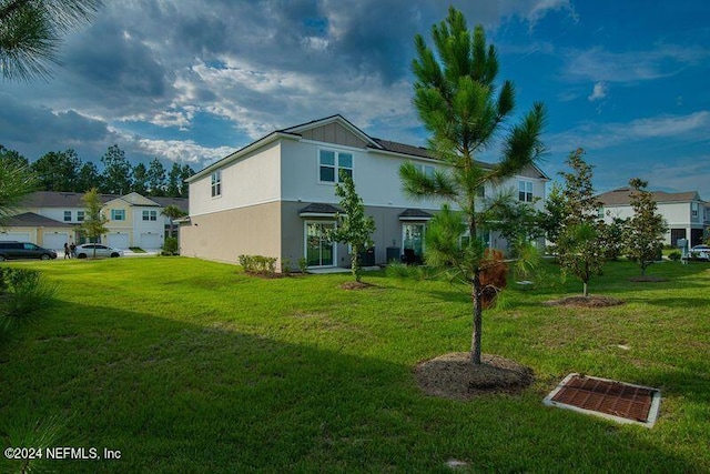 back of property featuring a lawn