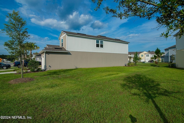 view of home's exterior featuring a yard