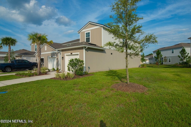 view of front of house featuring a garage and a front lawn