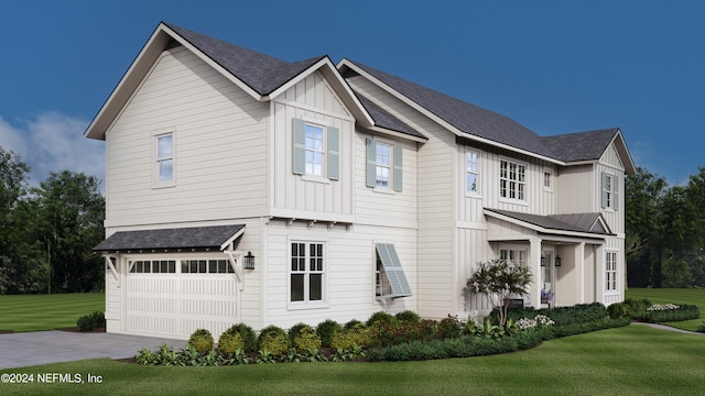 view of front of property with a front yard and a garage