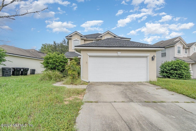 view of front of house featuring a front lawn and a garage