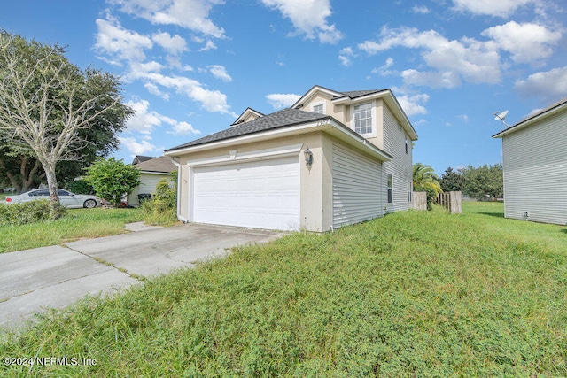 view of side of home featuring a garage and a yard