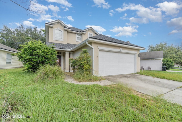 view of front of house featuring a garage and a front lawn