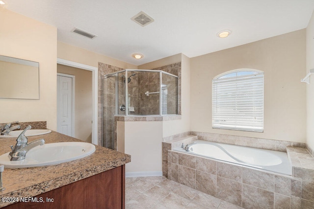 bathroom featuring separate shower and tub, tile patterned floors, and vanity