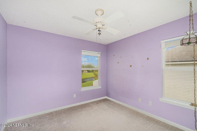 unfurnished room with carpet floors and ceiling fan