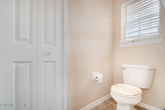 bathroom with tile patterned flooring and toilet