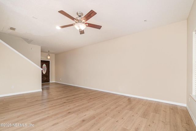 unfurnished room featuring baseboards, a ceiling fan, visible vents, and light wood-style floors